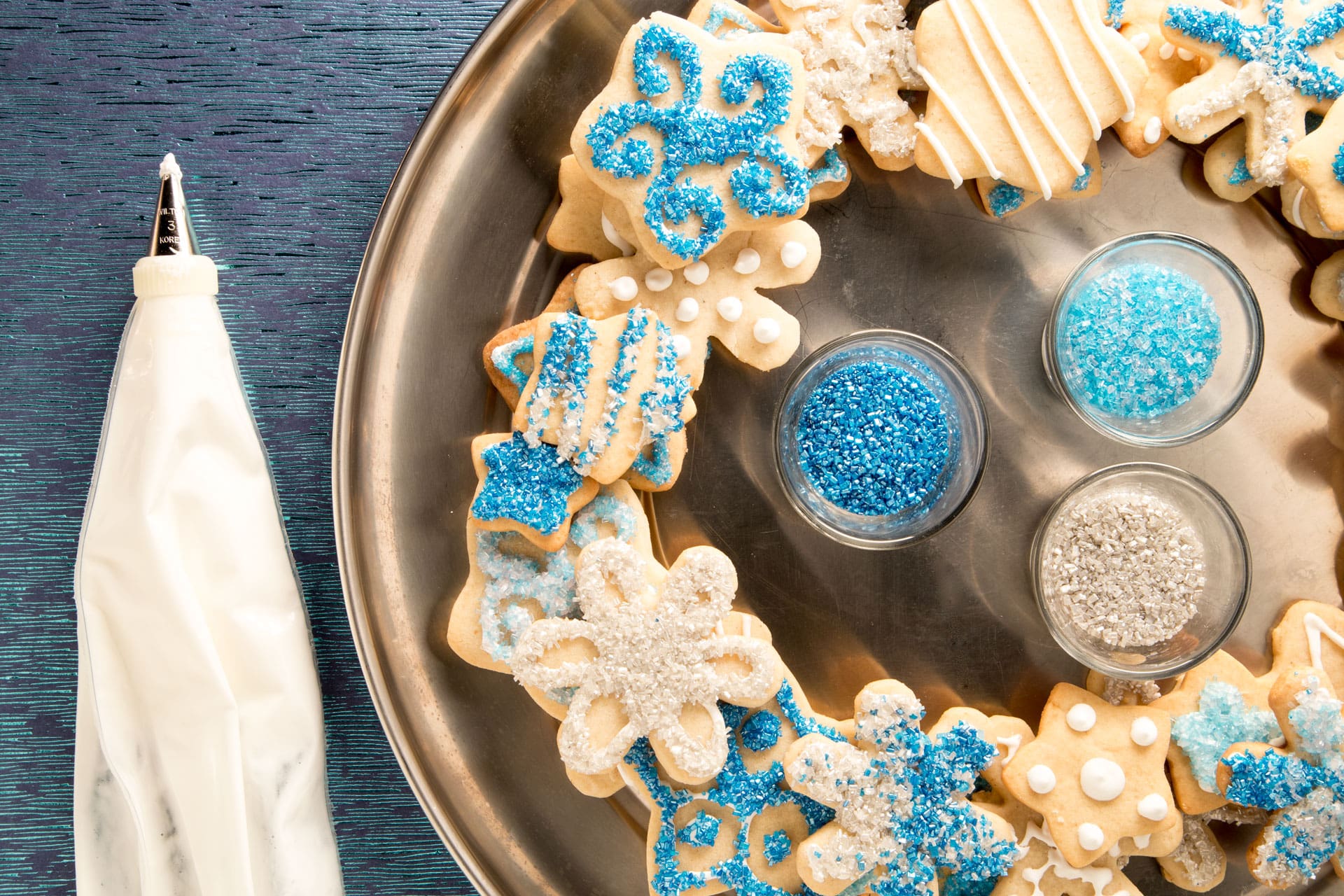 Cardamom Shortbread Snowflakes are a great rolled dough cookie that can be used for decorating OR eating. We prefer both, so we turned our cookies into a wreath (the ones we didn’t eat first, of course).